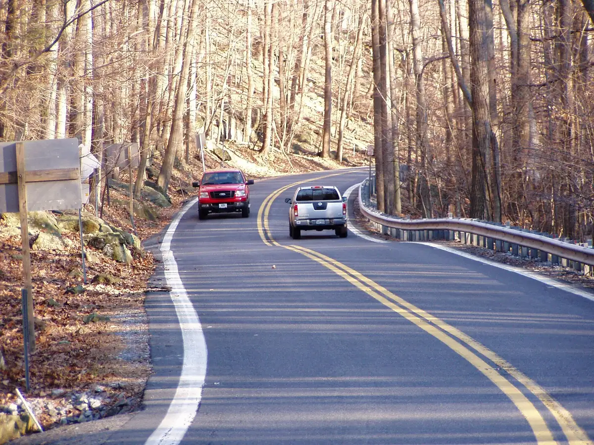 Two-lane Maryland Route 77 curving through bare winter woods between Catoctin Mountain Park and Cunningham Falls State Park