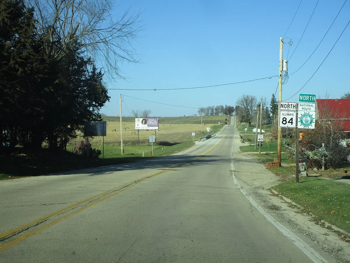 Two-lane Illinois Route 84, the Great River Road, heading north out of Hanover over rolling farmland