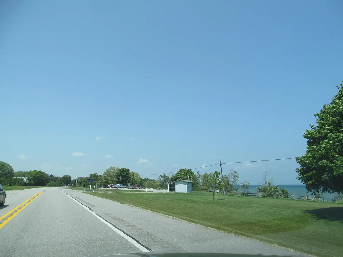 M-25 running along the Lake Huron shore of the Thumb under a clear sky