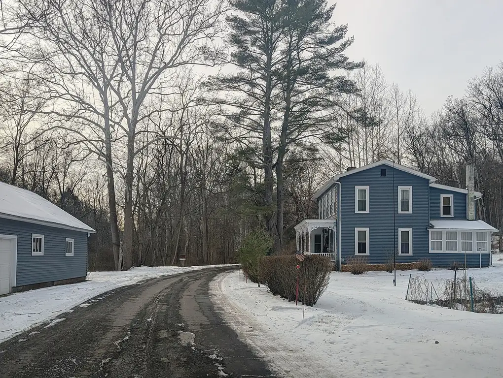 Old Mine Road bending past an old farmhouse in Flatbrookville, New Jersey, in winter